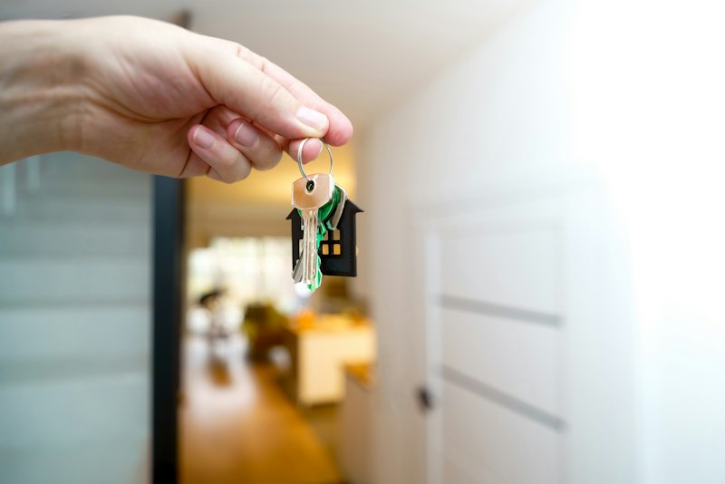 Holding house keys in front of the entrance